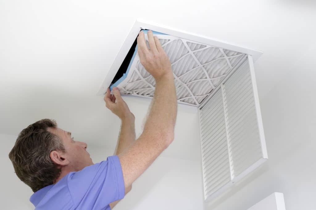 hvac technician installing a new air filter