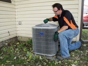 hvac technician evaluating an air conditioner