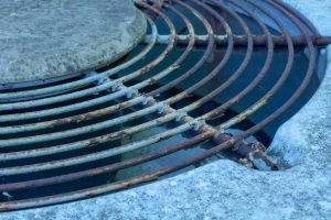 Rusty Fan Grate of a House AC Condenser