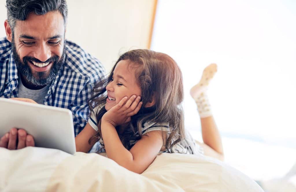 Improve your indoor air quality from allergens, dust, mold and breathe easier. Happy dad and daughter on laptop.