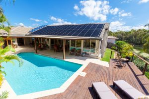 solar panels on roof and exterior view of backyard