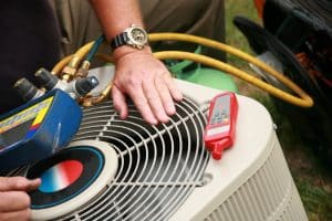 hvac technician evaluating an air conditioner