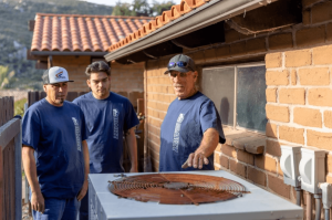 An old HVAC system outside a residence in San Diego county that needs to be replaced.